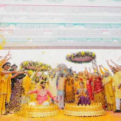 When the brief is "vibrant," we deliver! This 'phoolon ki haldi' was a riot of color, with guests showering the couple in marigold petals under a canopy of bright drapes.