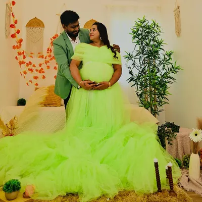 A stunning portrait featuring a vibrant lime green gown against the neutral tones of my Boho bedroom set. The long train of the dress adds a touch of drama to this beautiful maternity photo.