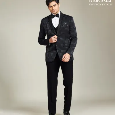 A model looking sharp and iconic in a modern black tuxedo. The jacket features a subtle, tone-on-tone pattern, perfect for the man who appreciates premium, understated style.