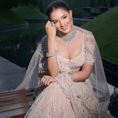 A classic monotone Tarun Tahiliani lehenga, styled for a fresh and elegant bridal look. The intricate embroidery and diamond jewellery create a feeling of timeless royalty.