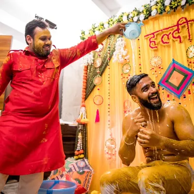 The quintessential Haldi moment. We capture the fun and chaos as friends and family douse the groom in water and turmeric paste.