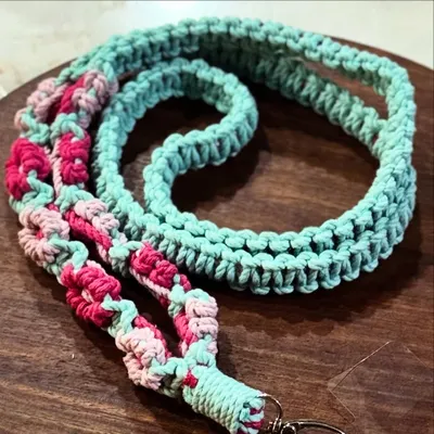 A beautiful multi-color lanyard with a floral design in mint, pink, and light pink. It's a fun and stylish way to carry your phone.