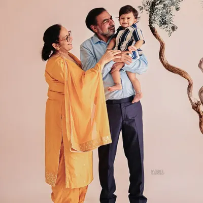 A priceless portrait of a baby boy with his grandparents. Including the whole family in a birthday photoshoot creates memories that connect generations.