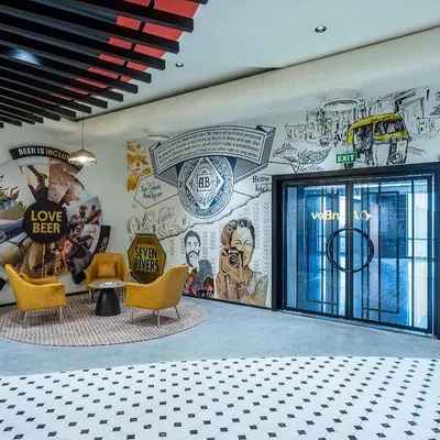 The reception mural at the AbInbev corporate office is the first thing visitors see. Spanning 60 feet, this piece was designed to tell the story of their brands in India, featuring a collage of imagery from an auto-rickshaw to local faces, all united by a love for beer.