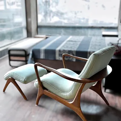 This custom armchair and matching ottoman feature elegant, curved teakwood frames, perfect for a serene bedroom corner. The design showcases our skill in creating handcrafted furniture with graceful, organic lines.
