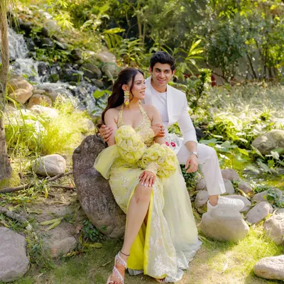 A serene portrait amidst the Haldi celebrations. Even in the middle of the joyful chaos, we find moments of quiet beauty. The lush green background contrasts beautifully with her yellow outfit.