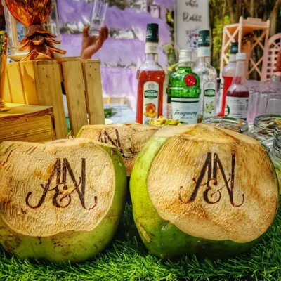 A close-up of my custom engraved coconuts, perfect for adding a personal and tropical touch to your wedding welcome drinks. The couple's initials are elegantly burned into the coconut shell for a memorable first sip.
