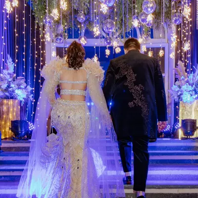 Making a grand entrance. I captured Sahas and Rozy from behind as they walked up the stairs to their sangeet, the dramatic lighting and their stunning outfits creating a truly cinematic moment.