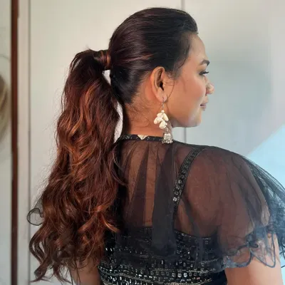 This textured ponytail is perfect for a Sangeet or reception. It keeps the hair off the face for dancing while still showing off beautiful length and volume, thanks to carefully blended extensions.