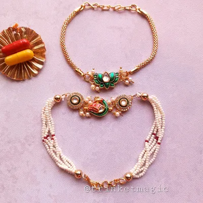 A beautiful Bhai Bhabhi Rakhi set featuring a peacock-inspired design for bhabhi and a matching lotus Rakhi for bhai. The pearl and beadwork make this a truly elegant choice.