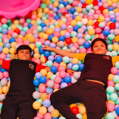 Just chilling in a sea of color. Our massive ball pit is a favorite spot for kids to relax, play, and make new friends.
