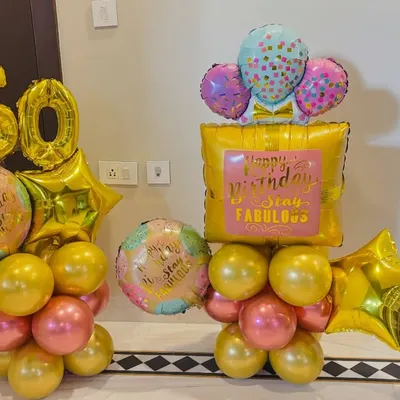 A compact and cheerful balloon setup for a 50th birthday. It features gold and pink balloons with a '50' foil number and other celebratory balloons.