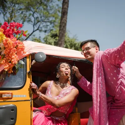 A quirky and fun Haldi moment with a decorated auto-rickshaw. This shot is all about capturing the couple's playful personality and the vibrant energy of the celebration.