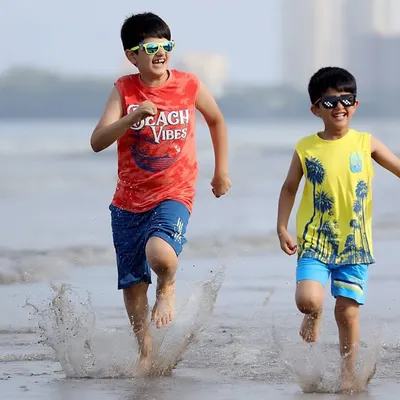 The simple joy of childhood captured as two brothers run along the shoreline. Our outdoor lifestyle shoots are perfect for energetic and candid family photos.