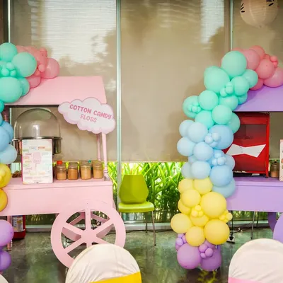 Our matching pastel pink and purple carts for cotton candy and popcorn, decorated with beautiful balloon garlands for a Hello Kitty party.