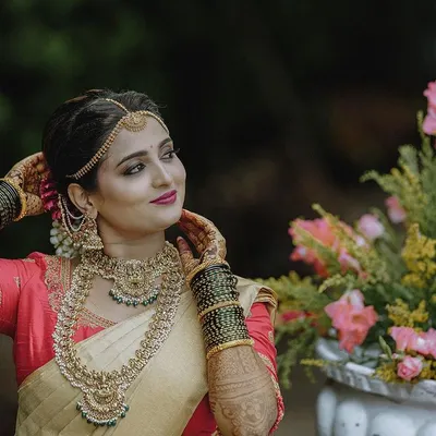 A beautiful candid portrait of a bride in her traditional wedding saree and jewellery. I love capturing these natural, in-between moments that show off the bride's personality and the elegance of her complete look.