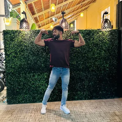 "Chill vibe." Taking a moment to relax and pose outside, showing that fitness is part of my life everywhere.