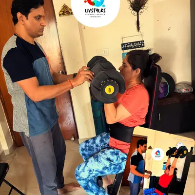 Personal guidance makes all the difference. Here, I'm assisting a client with proper form for a seated bicep curl on a bench, ensuring she engages the right muscles and avoids strain.