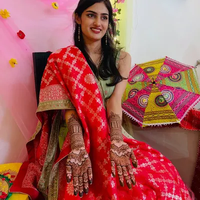 A radiant bride-to-be proudly showing her full bridal mehendi. Her happiness is what makes my work so fulfilling.