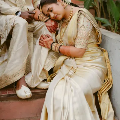 A moment of complete peace and trust. The bride rests, holding onto her partner's arm, in this serene and emotional portrait.