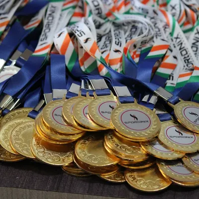A close-up of the gleaming gold medals ready to be awarded to the champions of our Anniversary Cup. We handle all the details.