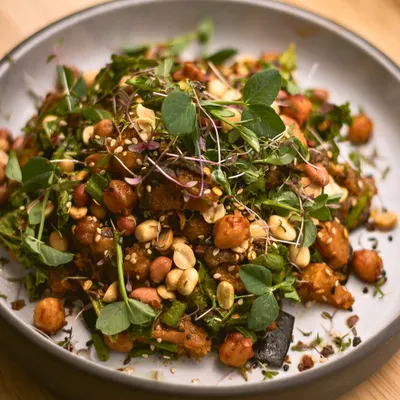 Our Asian Peanut Salad is a fan favourite for a reason. It combines the sweetness of roasted pumpkin, the crunch of peanuts, and the freshness of broccoli and kale with a miso-ginger dressing.
