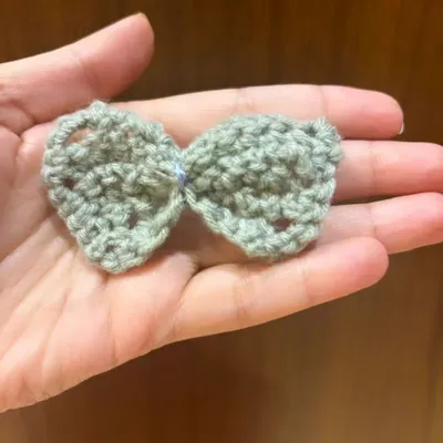 Look at this adorable little bow made by one of my students. They've been practicing the stitches we learned in class, and the results are just beautiful.