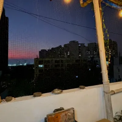 Welcome to my rooftop studio in Malad. This is the view that greets you during our evening workshops, a beautiful sunset over the city. It's the perfect, calming backdrop for getting creative.