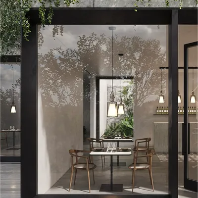 These elegant pendants create a perfect balance between tradition and modernity. Seen through a large window, they illuminate an intimate dining space, blending aesthetics with functionality.