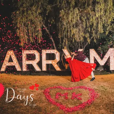 A grand proposal setup with marquee letters spelling "MARRY ME," used for a creative 10-day wedding countdown shoot.