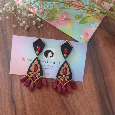These hand-painted earrings are a dramatic and elegant choice. I've used a combination of black, red, and gold on a multi-tiered fabric base to create a piece that is perfect for weddings and special events.
