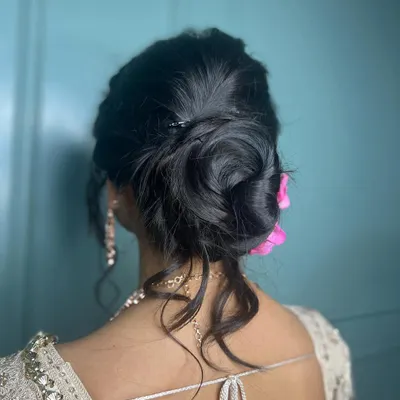 A beautiful and intricate messy bun, perfect for a reception or engagement. The soft tendrils frame the face beautifully.