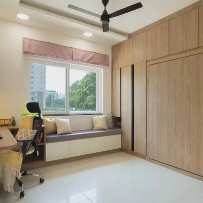 This guest room is designed to be a fully functional home office. The Murphy bed is completely concealed within the wooden cabinetry, providing a spacious work area without sacrificing the ability to host guests.