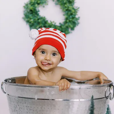 The pure, uninhibited joy of a splash session. This little one's cheeky grin and happy splashes make for an unforgettable photo.