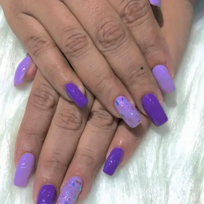 A fun and vibrant unicorn-inspired set using different shades of purple and a glitter accent nail.
