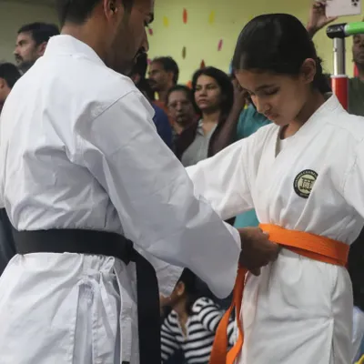 A significant moment for every student. Here, I am awarding a new belt, which is a symbol of their hard work, dedication, and progress on their karate journey.