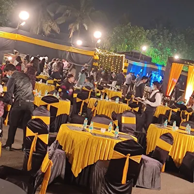 An elegant outdoor setup with black and yellow decor for the New Year's Eve bash we catered for the Indian Coast Guard.