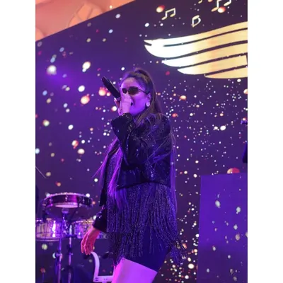 Our female vocalist, captured in her element. She brings a powerful voice and incredible stage presence to every performance, ensuring the energy levels are always at their peak.