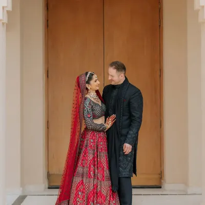 A classic, romantic portrait. I posed this couple against a simple, elegant backdrop to let their connection and stunning outfits be the focus.