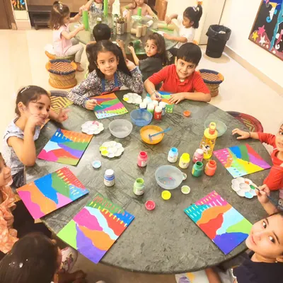 My adorable toddler group, aged 3 to 6, learning about color and strokes. Their happy faces and vibrant abstract paintings show just how much they enjoy the process of creation.