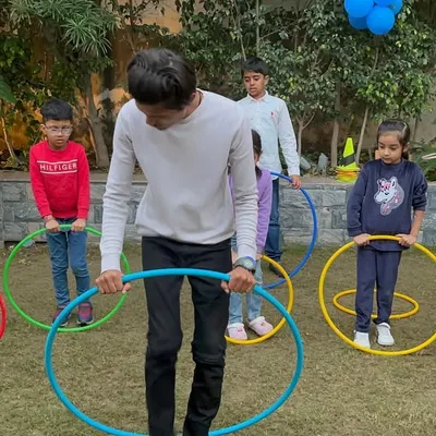 Learning to hula hoop is a great physical activity for kids of all ages. Here, an instructor guides the children during a fun session on our lawn.