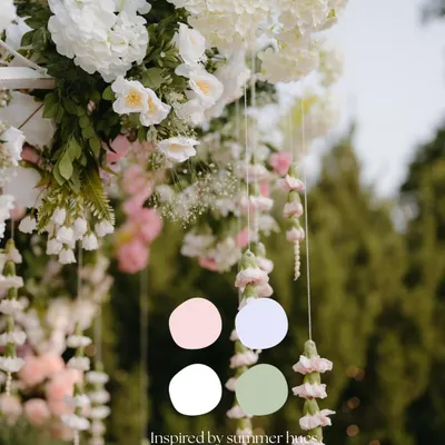 Inspired by summer hues, this image shows how I draw color palettes from nature itself. The hanging floral strings and lush white arrangements create a soft, romantic feel for an outdoor event.