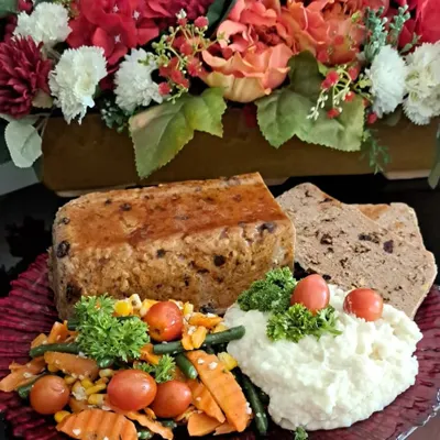 My Festive Meatloaf is a Christmas dinner centerpiece I'm truly proud of. It's a rich and savory loaf made with chicken, bacon, and fruits, beautifully plated with mash and veggies.