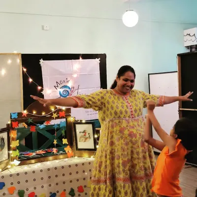 The pure joy of connection! A child reaches out during an interactive part of our story session. We encourage movement and participation to make learning active and fun.