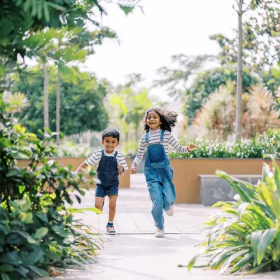 Let them run. My favorite shots are often the ones in motion, capturing the pure energy and happiness of siblings playing together in a beautiful outdoor setting.
