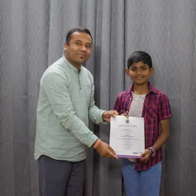 I am delighted to award a student his certificate for passing his graded music exam. I take great pride in my students' formal achievements.