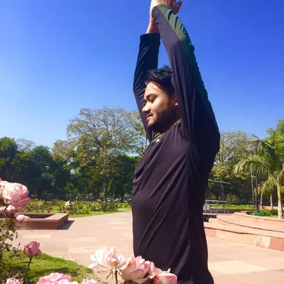 During times of uncertainty, your breath is your anchor. Here, I am practicing a simple standing stretch, focusing on deep breathing to calm anxiety. This picture is a reminder to use the tools of yoga to find stability.