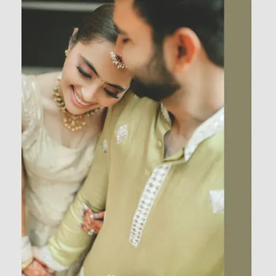 A beautifully soft and intimate portrait. The bride's serene expression as she rests her head on the groom's shoulder speaks volumes about their comfort and deep connection.