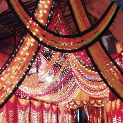 This is a grand entrance gate I decorated for a large event. I used layers of marigold garlands and bright fairy lights to build a traditional and welcoming entryway for guests arriving at the venue.