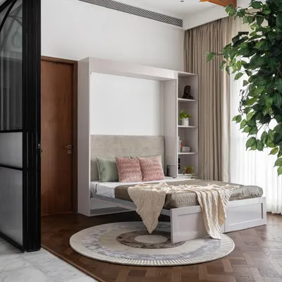 This multifunctional room is a perfect example of smart design. It serves as a cozy den by day, and transforms into a comfortable guest room at night thanks to the stylish and easy-to-use Murphy bed.